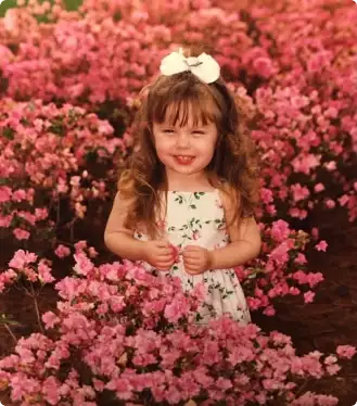 Madison as a young child among flowers